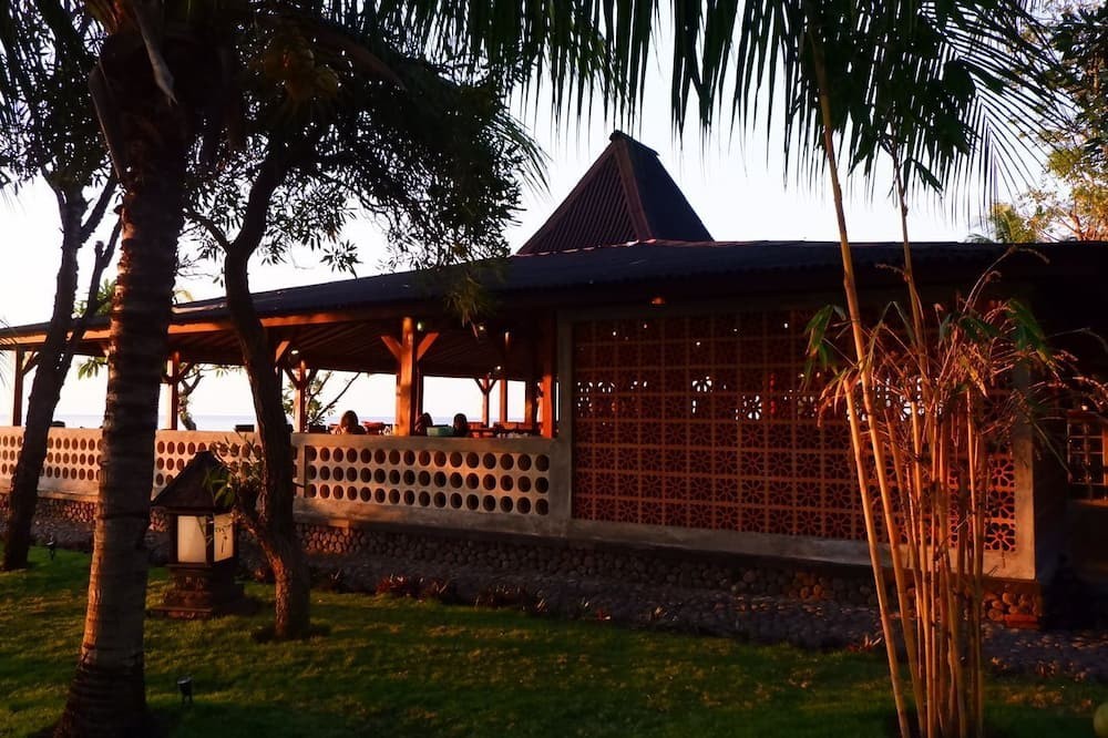Expedia dynamic catalog ad showing a sunset photo of the beachfront Mina Tanjung Hotel property pulled from the feed