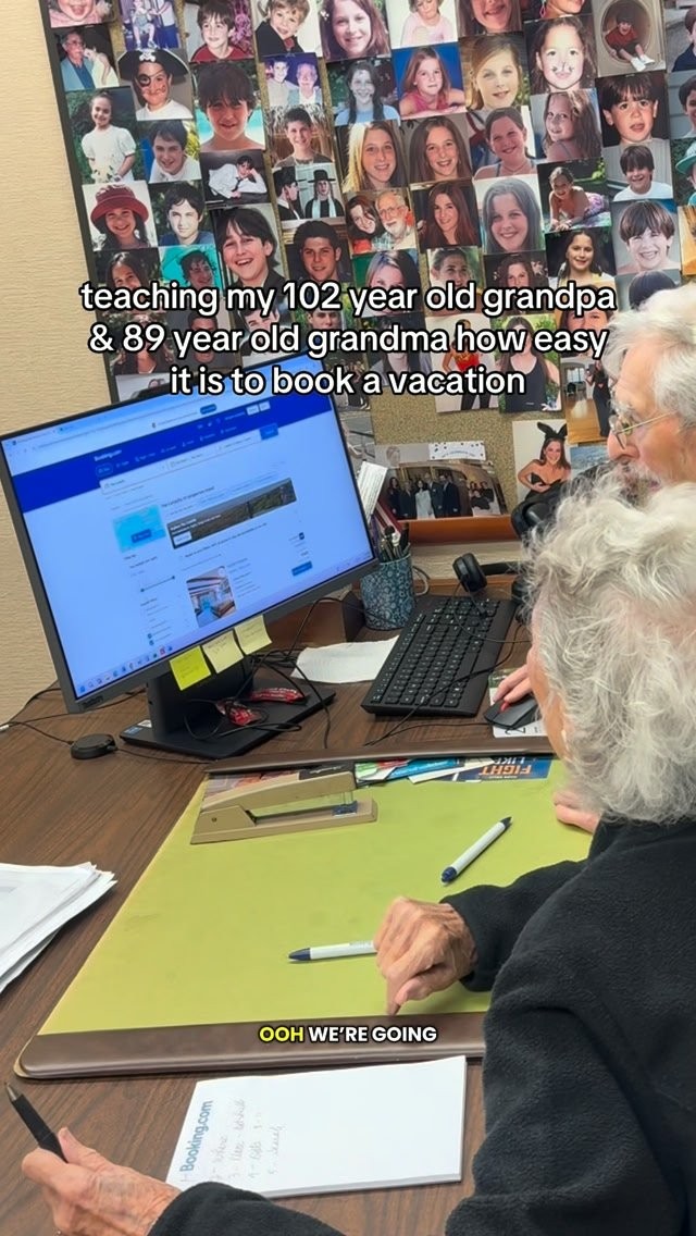 Booking.com creator-style video ad, a person at a desk helping an elderly relative book a stay on the Booking.com site with an on-screen caption about teaching a 102 year old grandpa and 89 year old grandma to book a vacation